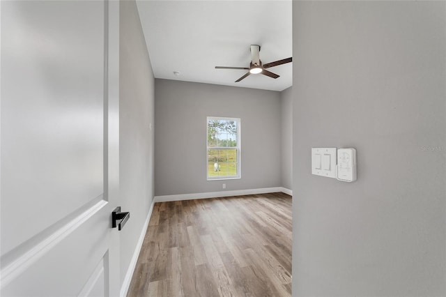 empty room with light hardwood / wood-style floors and ceiling fan