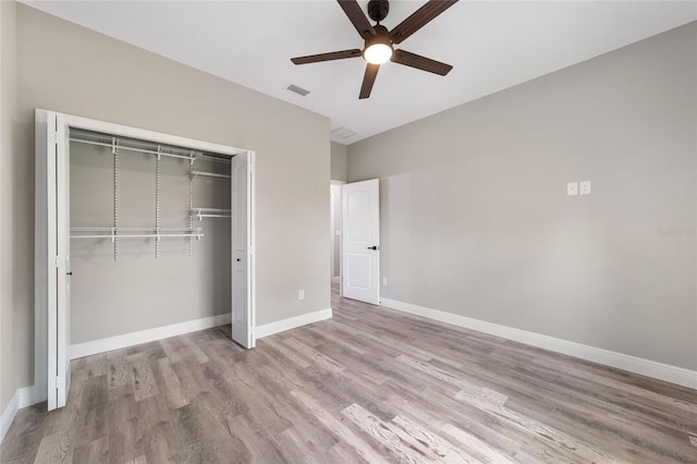 unfurnished bedroom featuring a closet, ceiling fan, and light hardwood / wood-style flooring