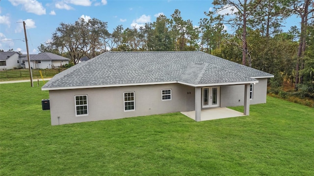 back of house with french doors, a patio, and a yard