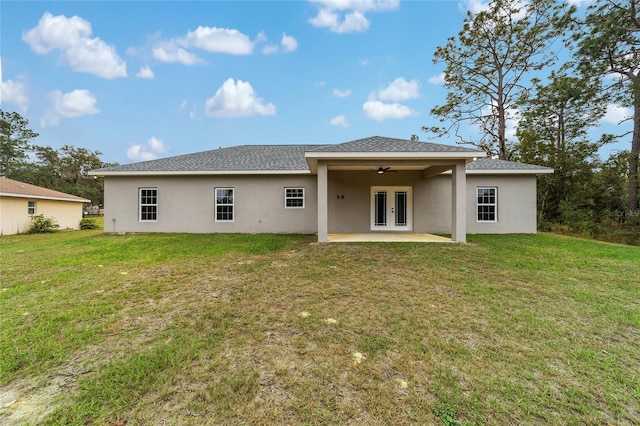 back of house featuring a lawn, ceiling fan, a patio, and french doors