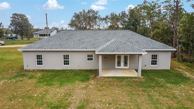 back of property with french doors, a yard, and a patio area