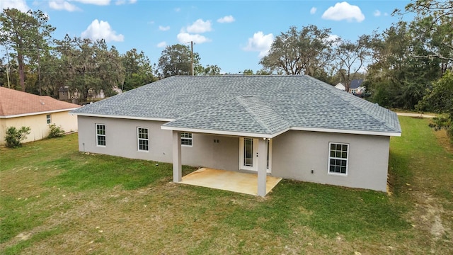 rear view of property with a patio area and a yard