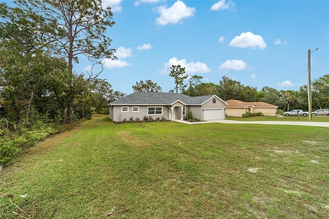 ranch-style house featuring a front lawn and a garage