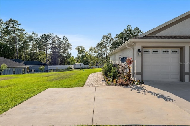 view of side of home with a lawn and a garage