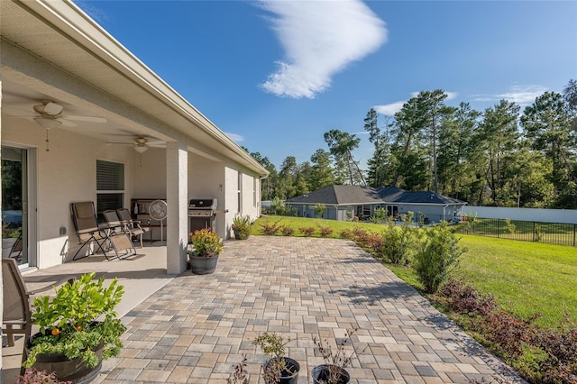 view of patio featuring ceiling fan and a grill