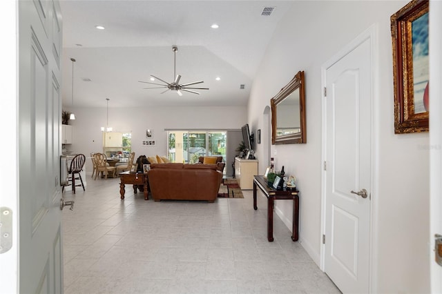 living room featuring ceiling fan and lofted ceiling