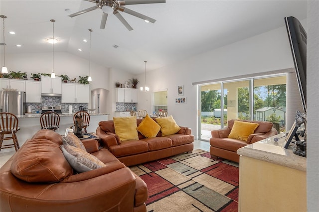 living room with ceiling fan with notable chandelier and high vaulted ceiling