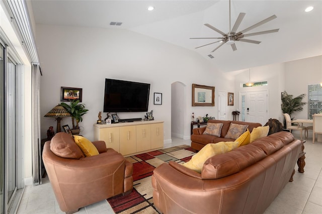 tiled living room featuring ceiling fan and lofted ceiling