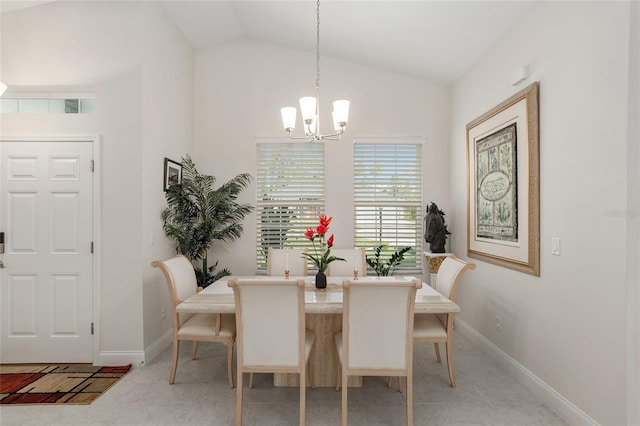 dining area featuring an inviting chandelier and vaulted ceiling