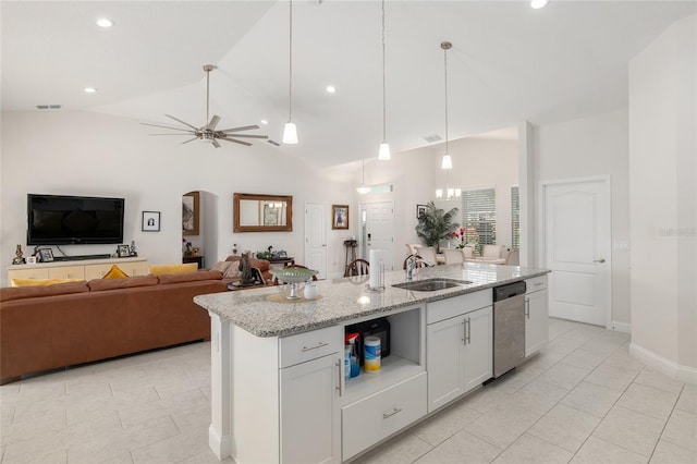 kitchen with white cabinets, dishwasher, lofted ceiling, and an island with sink