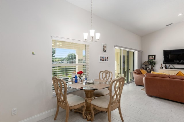 dining space with a chandelier and high vaulted ceiling