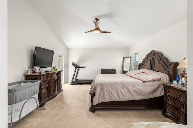 bedroom with multiple windows, ceiling fan, light colored carpet, and vaulted ceiling