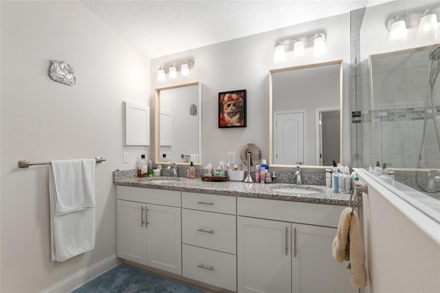 bathroom featuring vanity, a textured ceiling, and walk in shower