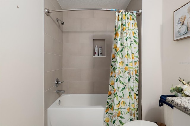 bathroom featuring shower / bath combo, toilet, and a textured ceiling