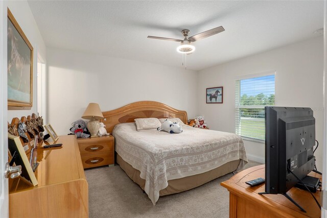 carpeted bedroom with ceiling fan