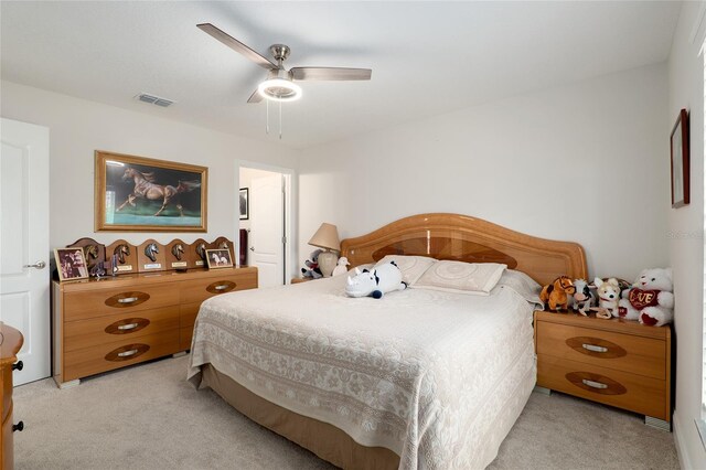 bedroom featuring ceiling fan and light carpet