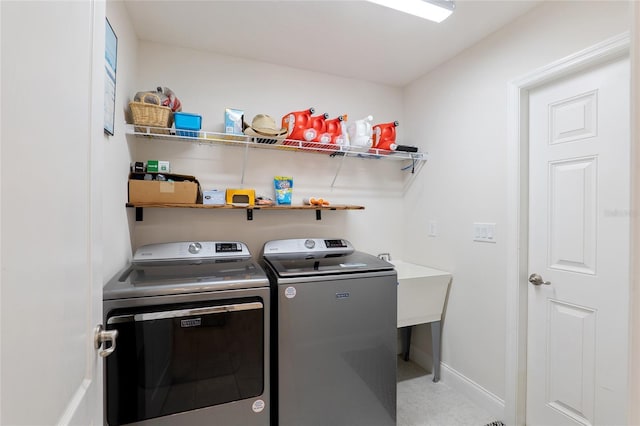 washroom featuring washer and clothes dryer