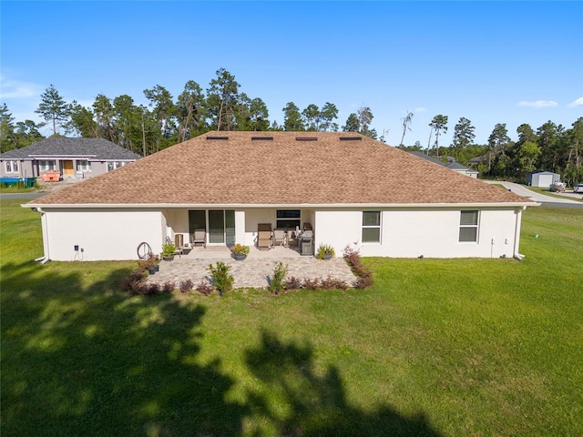 rear view of house featuring a patio area and a yard