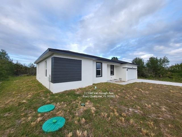 view of front of property with a garage and a front lawn