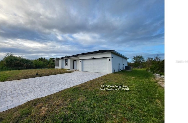 view of front of home featuring a garage and a front lawn