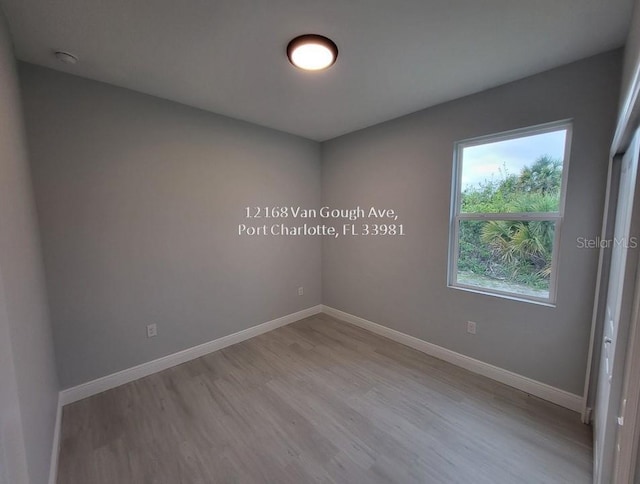 empty room with light hardwood / wood-style flooring