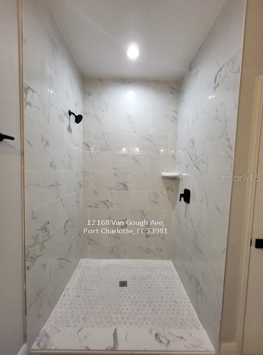 bathroom with a tile shower