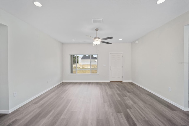 empty room with hardwood / wood-style flooring and ceiling fan