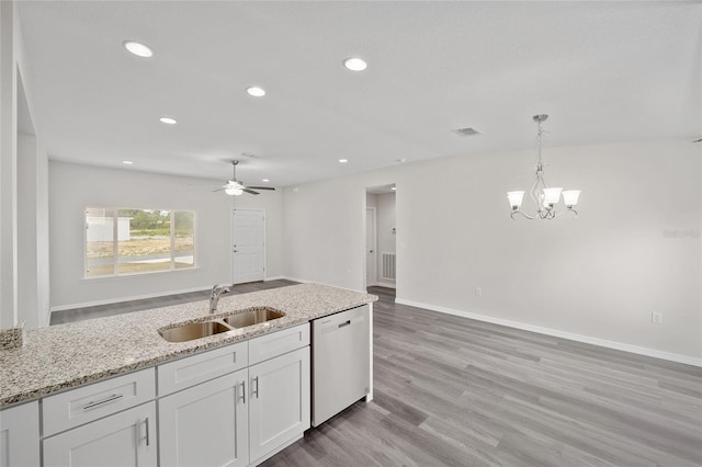 kitchen featuring sink, stainless steel dishwasher, light hardwood / wood-style floors, light stone counters, and white cabinetry