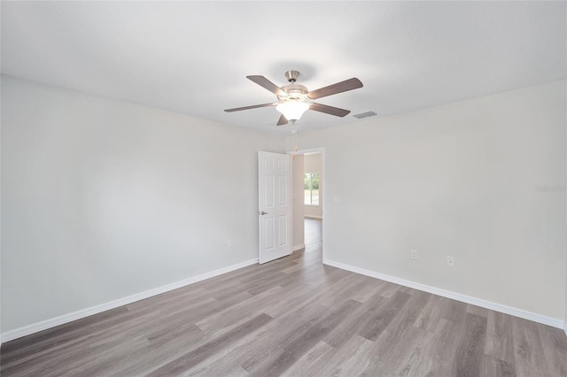 empty room featuring ceiling fan and light hardwood / wood-style floors