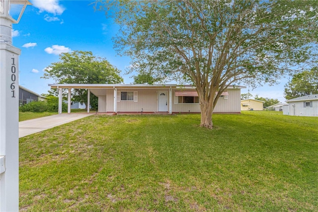 ranch-style house with a front yard and a carport