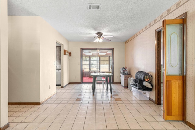 dining space featuring ceiling fan, light tile patterned flooring, and a textured ceiling