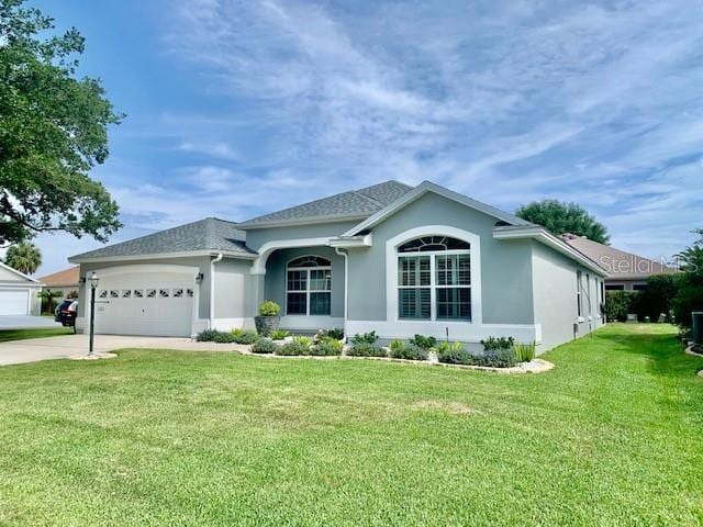 ranch-style home featuring a front lawn and a garage