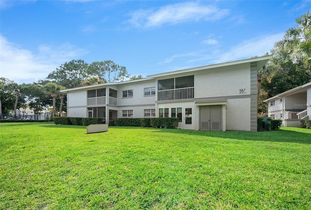 rear view of house featuring a yard