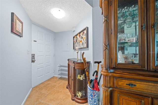 doorway to outside with a textured ceiling