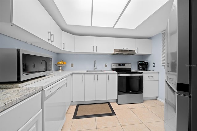 kitchen featuring white cabinets, sink, light tile patterned floors, and stainless steel appliances