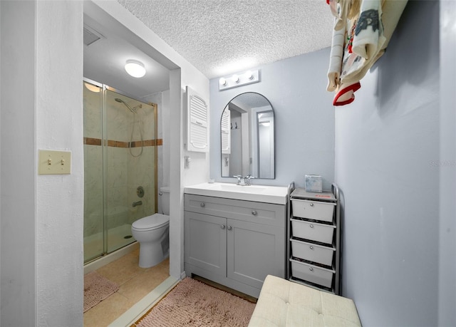 bathroom with vanity, toilet, an enclosed shower, and a textured ceiling