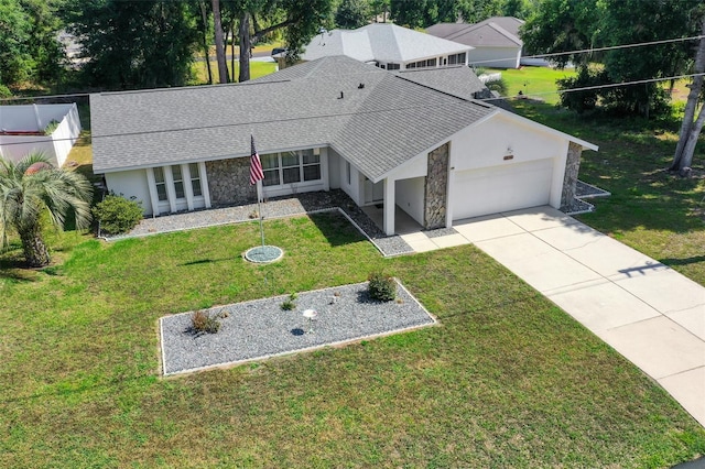 view of front of home featuring a garage, a shingled roof, stone siding, concrete driveway, and a front lawn