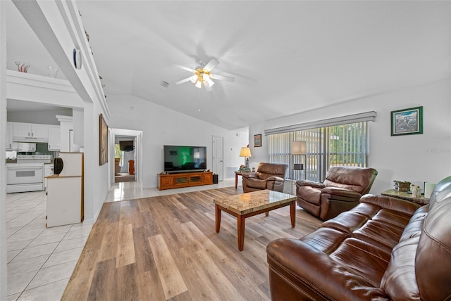 living room with light tile patterned floors, ceiling fan, lofted ceiling, and visible vents