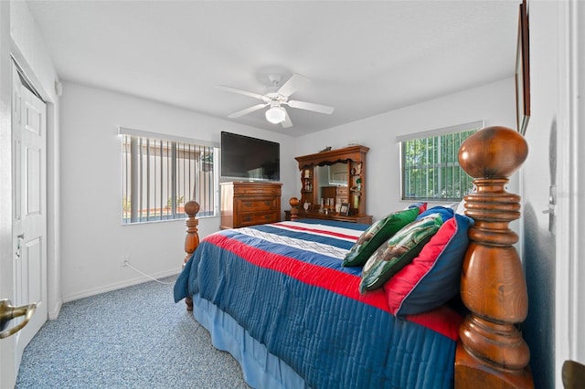 carpeted bedroom featuring ceiling fan, a closet, and baseboards