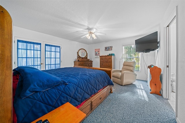 bedroom with a textured ceiling, a ceiling fan, and carpet flooring