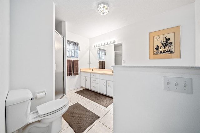 full bathroom featuring double vanity, toilet, a sink, a shower stall, and tile patterned flooring