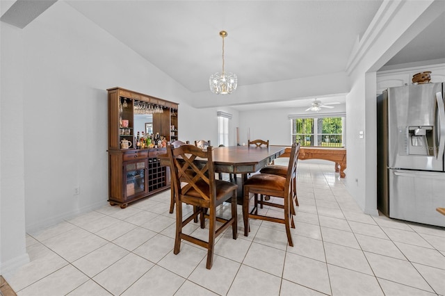 dining room with lofted ceiling, a dry bar, light tile patterned flooring, and a notable chandelier