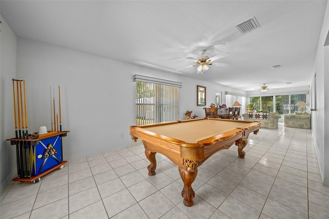 recreation room with visible vents, plenty of natural light, and light tile patterned floors