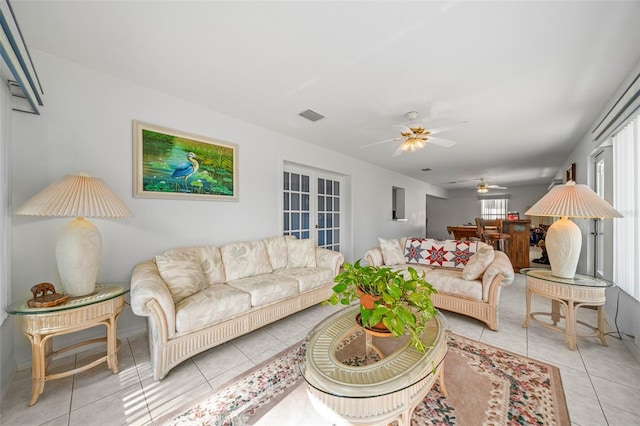 living area featuring ceiling fan, light tile patterned flooring, and visible vents