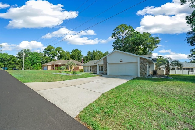 ranch-style home with a garage, concrete driveway, stone siding, central air condition unit, and a front yard