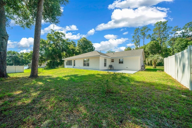 back of house with a lawn, a patio area, and fence