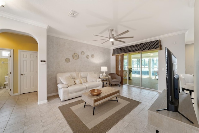 tiled living room with ceiling fan and crown molding