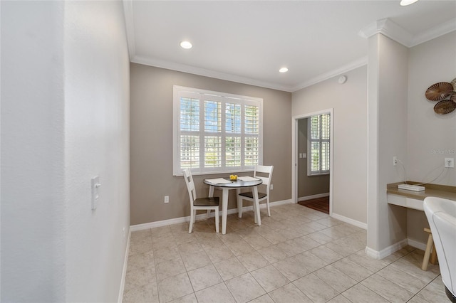 dining room with crown molding and light tile patterned floors