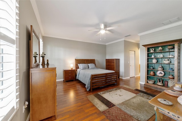 bedroom with ceiling fan, crown molding, and dark wood-type flooring