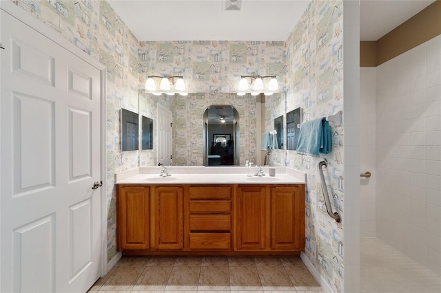 bathroom with tile patterned floors, ceiling fan, a shower, and vanity